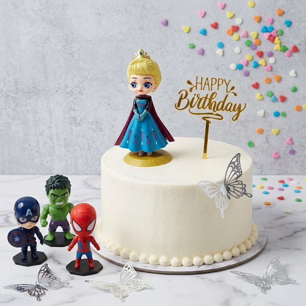 White frosted birthday cake decorated with an Elsa-style doll topper, gold Happy Birthday acrylic sign, superhero toy figurines, and silver laser-cut butterfly toppers.