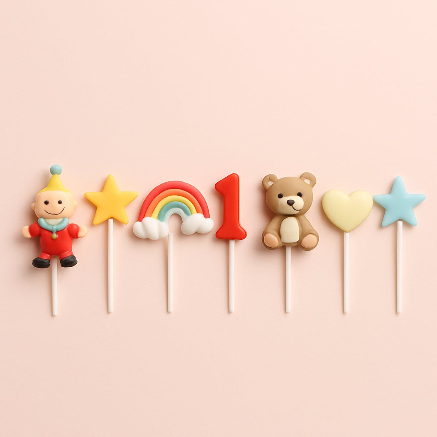 Variety of colorful cake toppers displayed on a pink and green background – perfect for adding a unique touch to birthdays, weddings, and special occasions.