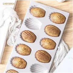 12 in 1 Madeleine Muffin & Cupcake Baking Tray in use, baking madeleines and cupcakes in the kitchen.