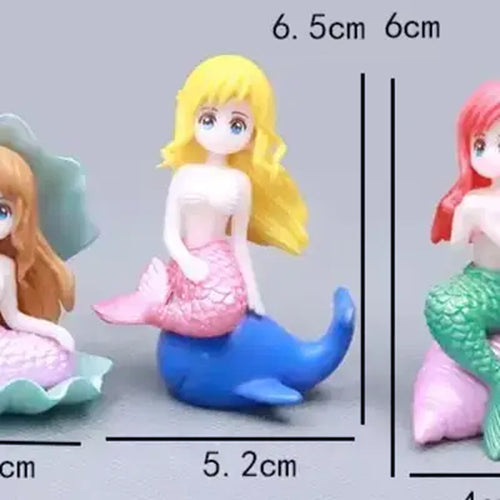 Blonde-haired miniature mermaid figurine with pink tail sitting on a blue dolphin – 6.5 cm ocean-themed cake topper ideal for mermaid birthday cakes, under the sea party decorations, and resin collectible decorations.
