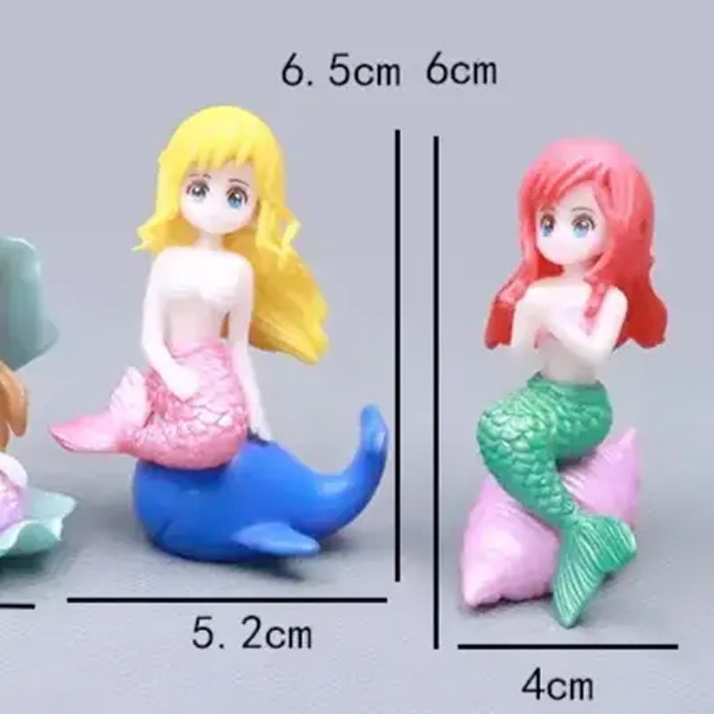 Miniature mermaid figurines for cake toppers – one with long blonde hair and pink tail sitting on a blue dolphin (6.5 cm), and another with red hair and green tail on a pink seashell (6 cm) – ideal for under the sea birthday cakes, mermaid party decorations, and ocean-themed fondant toppers.