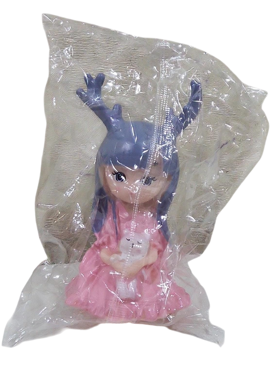 Cute deer girl cake toy topper with pink dress and blue hair in a clear Transparent Packet on a white background