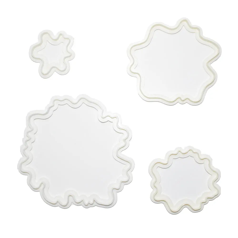 Peony-shaped cookie and fondant cutouts made using the 4 Piece Peonies Cookie Cutter, aligned on a white background