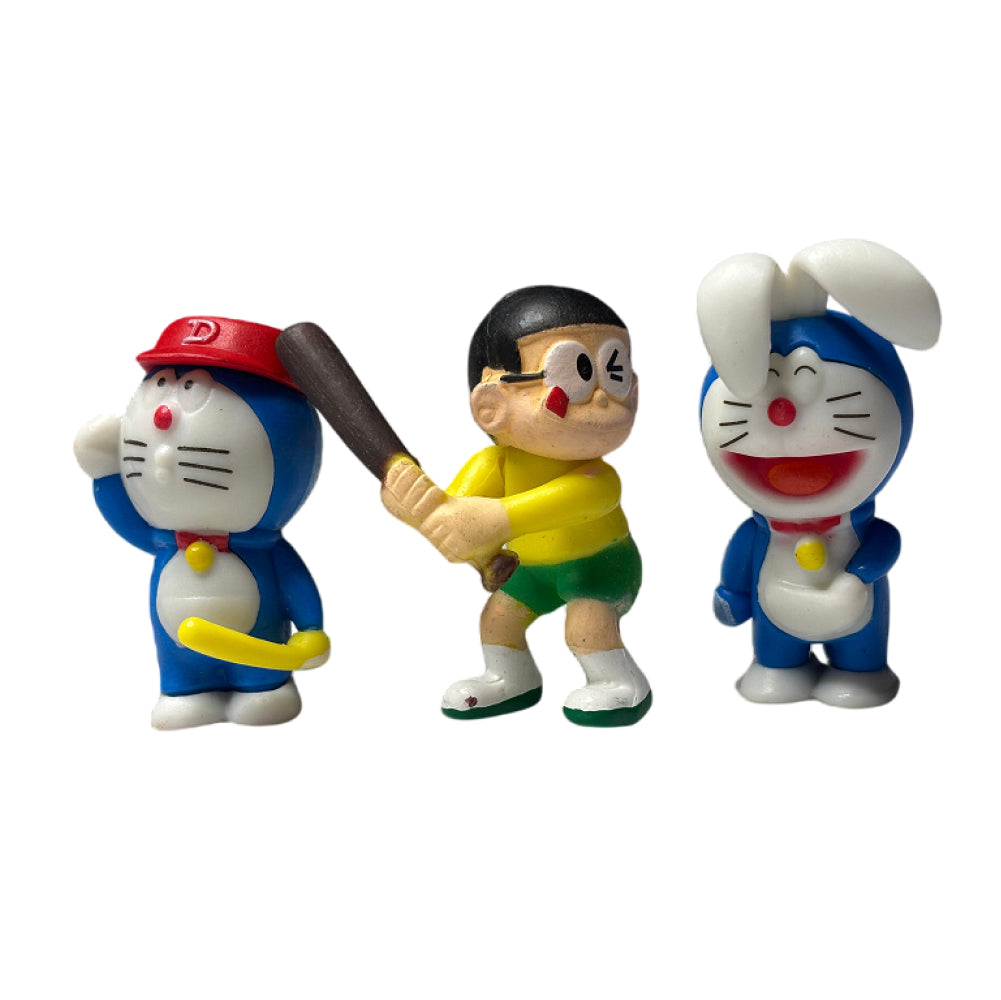 Close-up angled view of 3 Doraemon Cake Toppers on white background