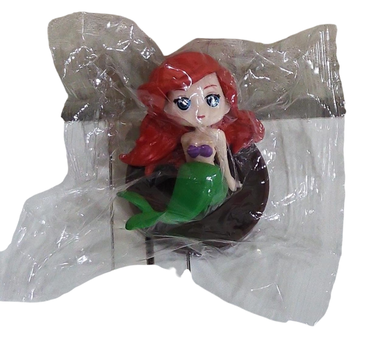 Mermaid figurine in a transparent plastic bag on a transparent background