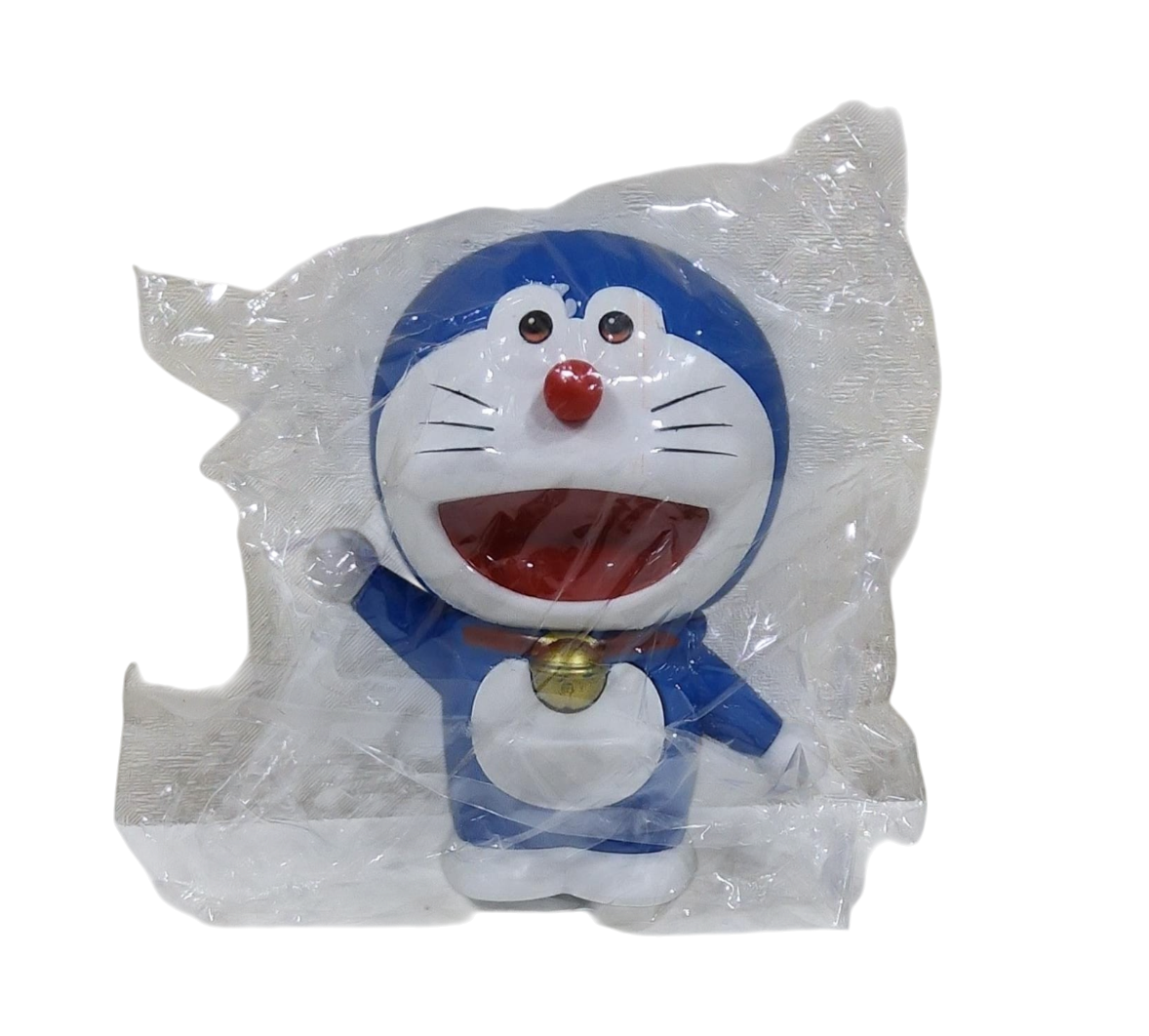 Plastic toy figure of a doreamon character in a transparent packaging on a transparent background