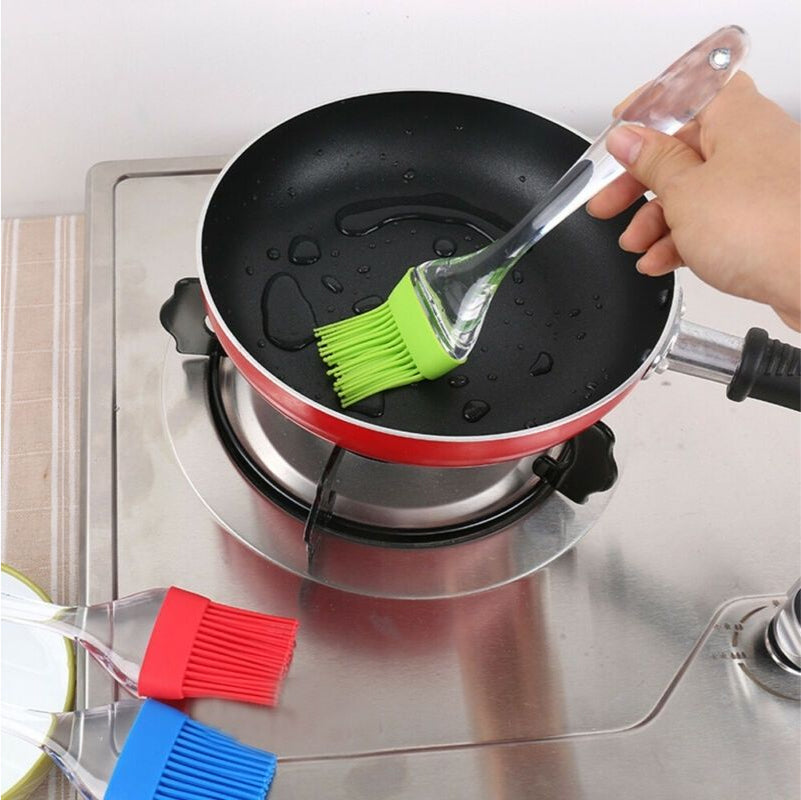 Image demonstrating the Big Silicone Brush in use for spreading butter on bread, showcasing its practical application.