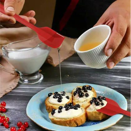 Image demonstrates the Big Silicone Spatula in use, mixing batter in a glass bowl, showcasing its versatility and functionality.