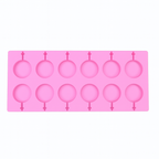 Pink silicone chocolate mold with a lollipop designs on a white background