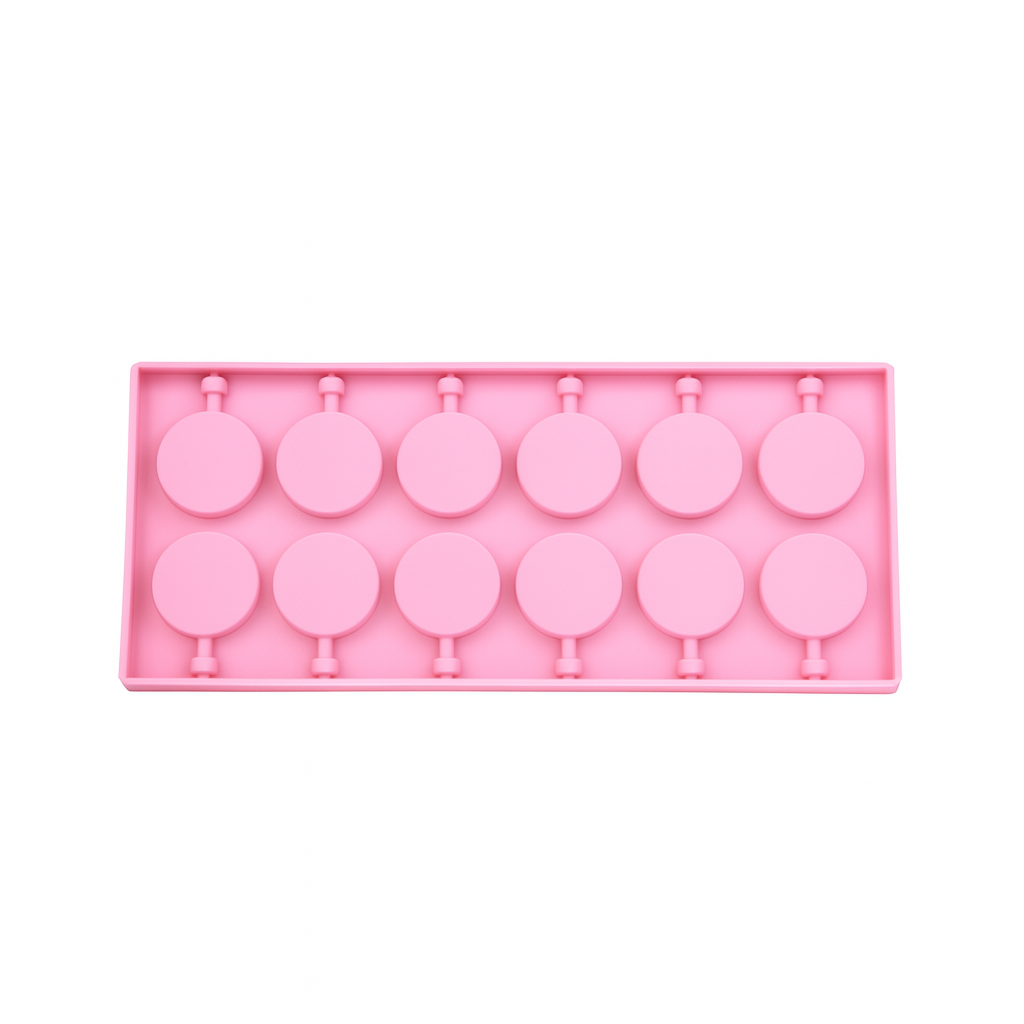Pink silicone chocolate mold with lollipop shapes on a white background