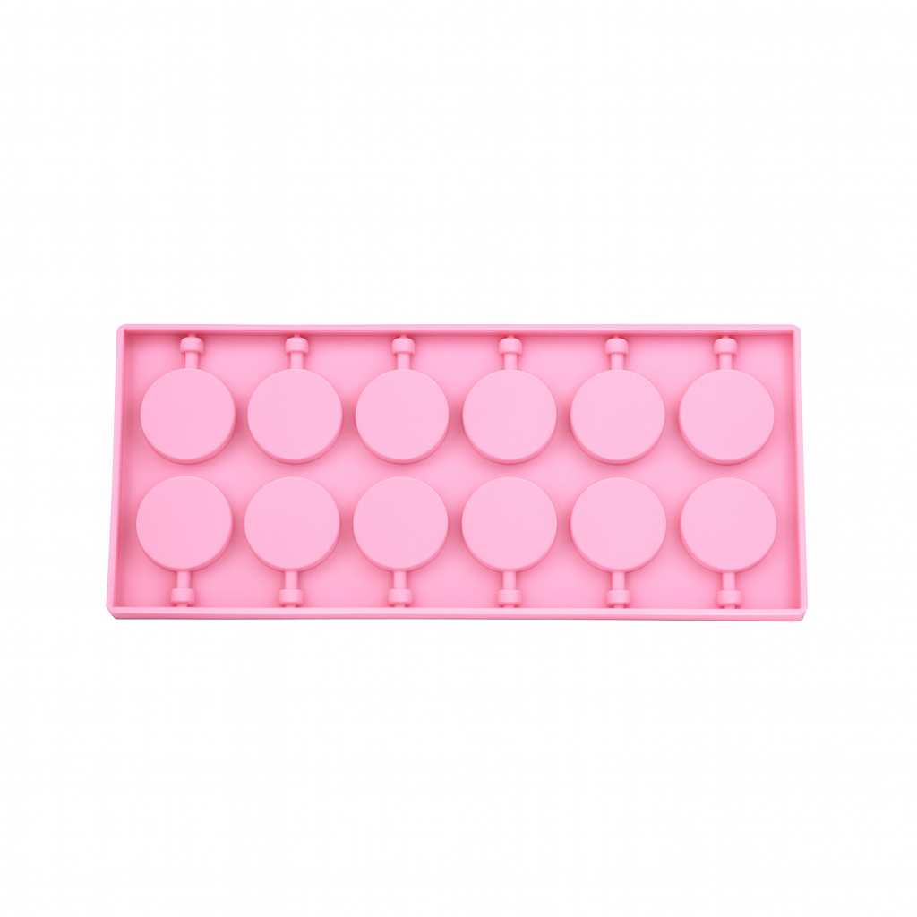 Pink silicone chocolate mold with lollipop shapes on a white background