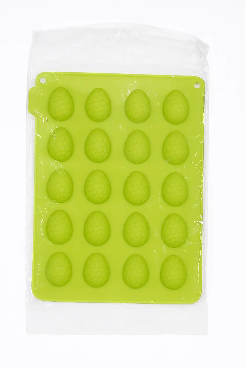 Green silicone chocolate mold for making eggs, easter-themed, in its packet, on a white background