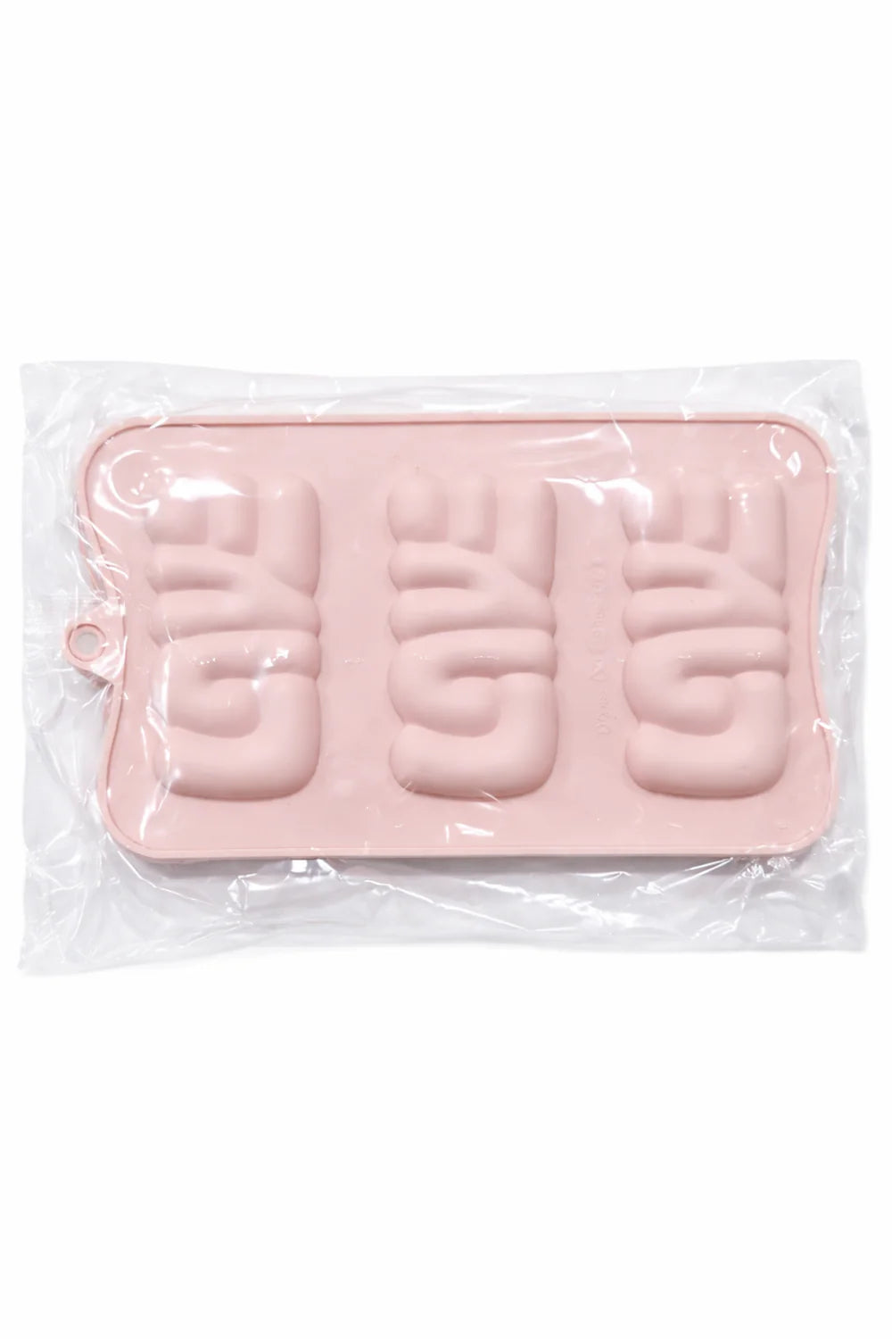 Pink silicone chocolate mold for making chocolates in clear packaging on a white background