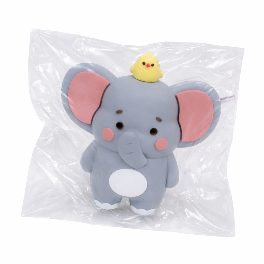 Plush elephant toy with a chick in clear transparent packaging on a white bckground.