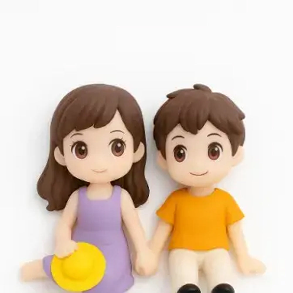 Cute couple mini figurine set – girl in lavender dress holding yellow hat and boy in orange shirt – sitting pose for cake decor and gifting