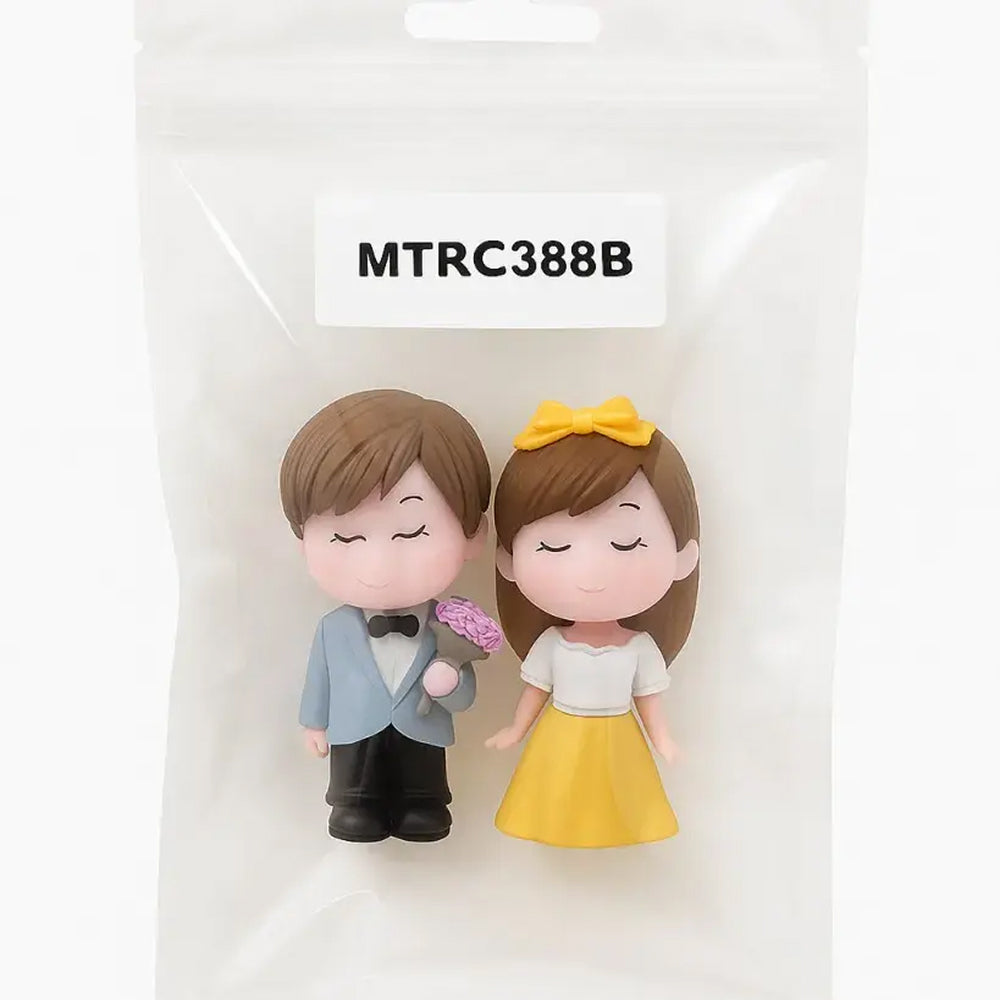 Couple miniature set labeled MTRC388B – romantic figurines with boy and girl in formal outfits, sealed packaging for gifting, cake decoration, and wedding favors.