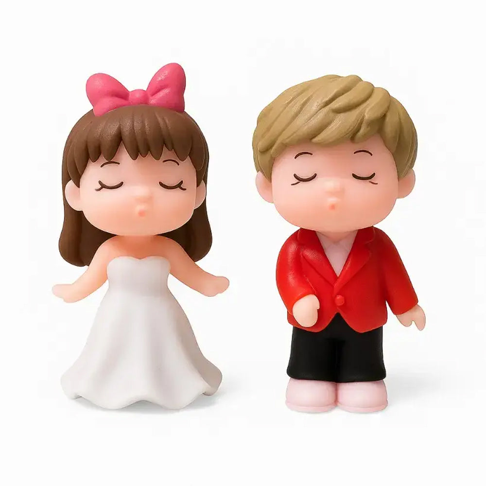 Cute closed-eyes couple figurines with pink bow, white gown, and red jacket – charming wedding or anniversary cake topper for romantic celebrations.