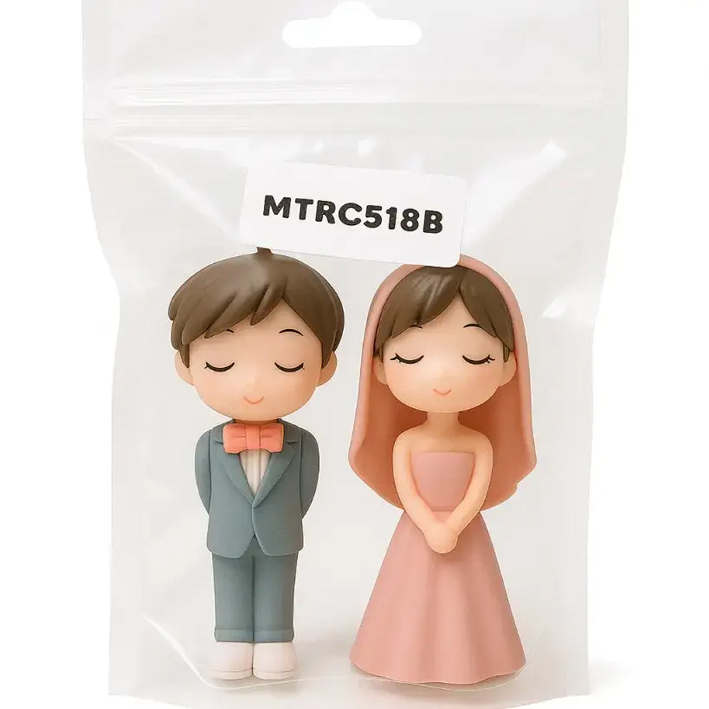 Plastic couple miniature packed in a clear pouch labeled MTRC518B – boy in teal suit with coral bowtie and girl in soft pink strapless gown and veil, ideal for wedding theme decorations