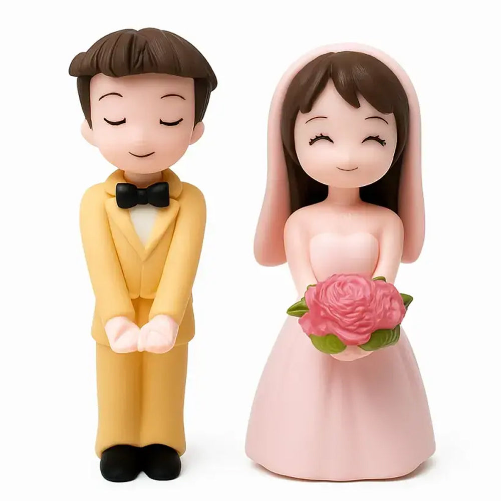 Miniature bride and groom couple figurines – groom in yellow suit with bow tie and bride holding pink bouquet, ideal for wedding cakes, fondant decorations, and anniversary displays.