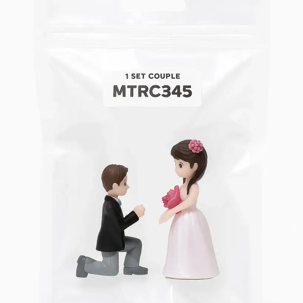 Cute romantic proposal scene with boy kneeling in black suit and girl in pink dress with flowers – packaged version – MTRC345 – for wedding cake toppers and gifting.