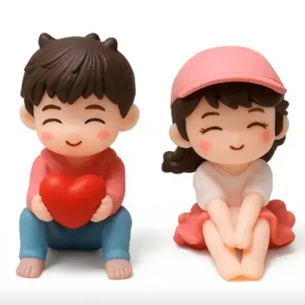 Cute miniature love couple figurines – smiling boy in red with heart and girl in white top and pink cap, ideal for romantic fondant cakes and couple decoration gifts."