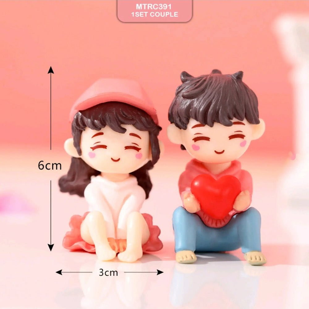 Miniature romantic couple figurine – boy holding red heart and girl in cap sitting side by side, 6 cm tall cake topper for Valentine's Day, wedding, and anniversary decorations.