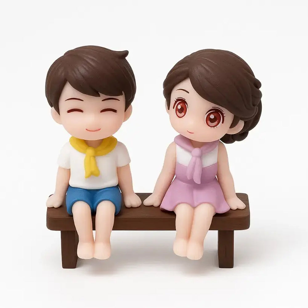Cute bench-sitting couple miniature – boy in yellow scarf and girl in pink outfit – cartoon-style topper for Valentine’s Day cakes and dioramas