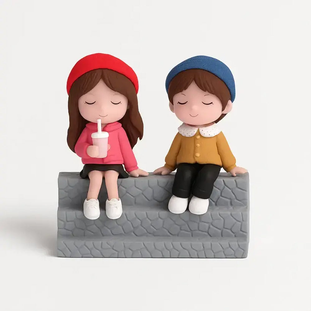 Miniature girl in red cap sipping a milkshake alongside a friend in a mustard top, sitting on a grey-textured bench – playful figurine for cute cake decor