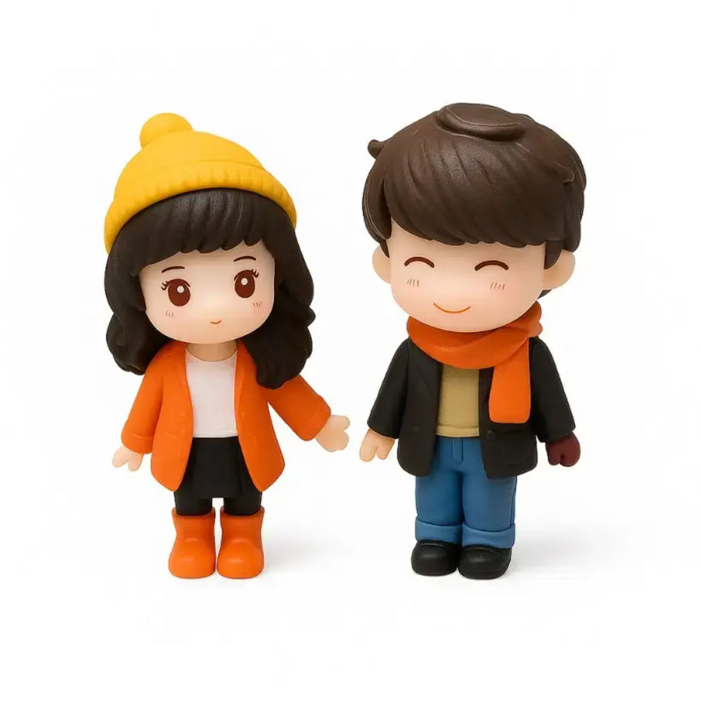 Miniature boy and girl winter couple figurines in orange and black outfits with beanies – sweet choice for cake decorations, dioramas, and displays.