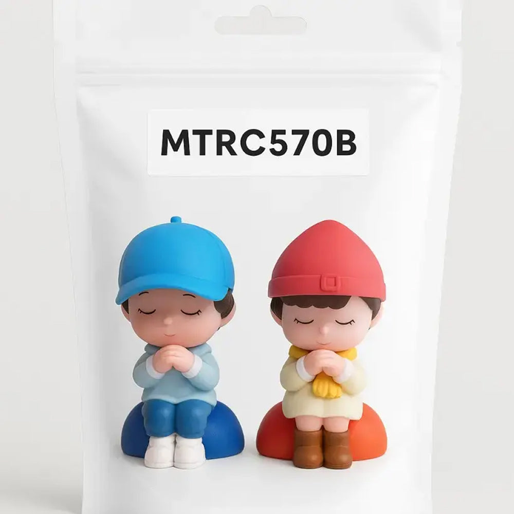 Miniature boy and girl figurines in colorful outfits sitting on red and blue cushions with hands in prayer pose – MTRC570B model – packaged version for cake decoration or crafts.