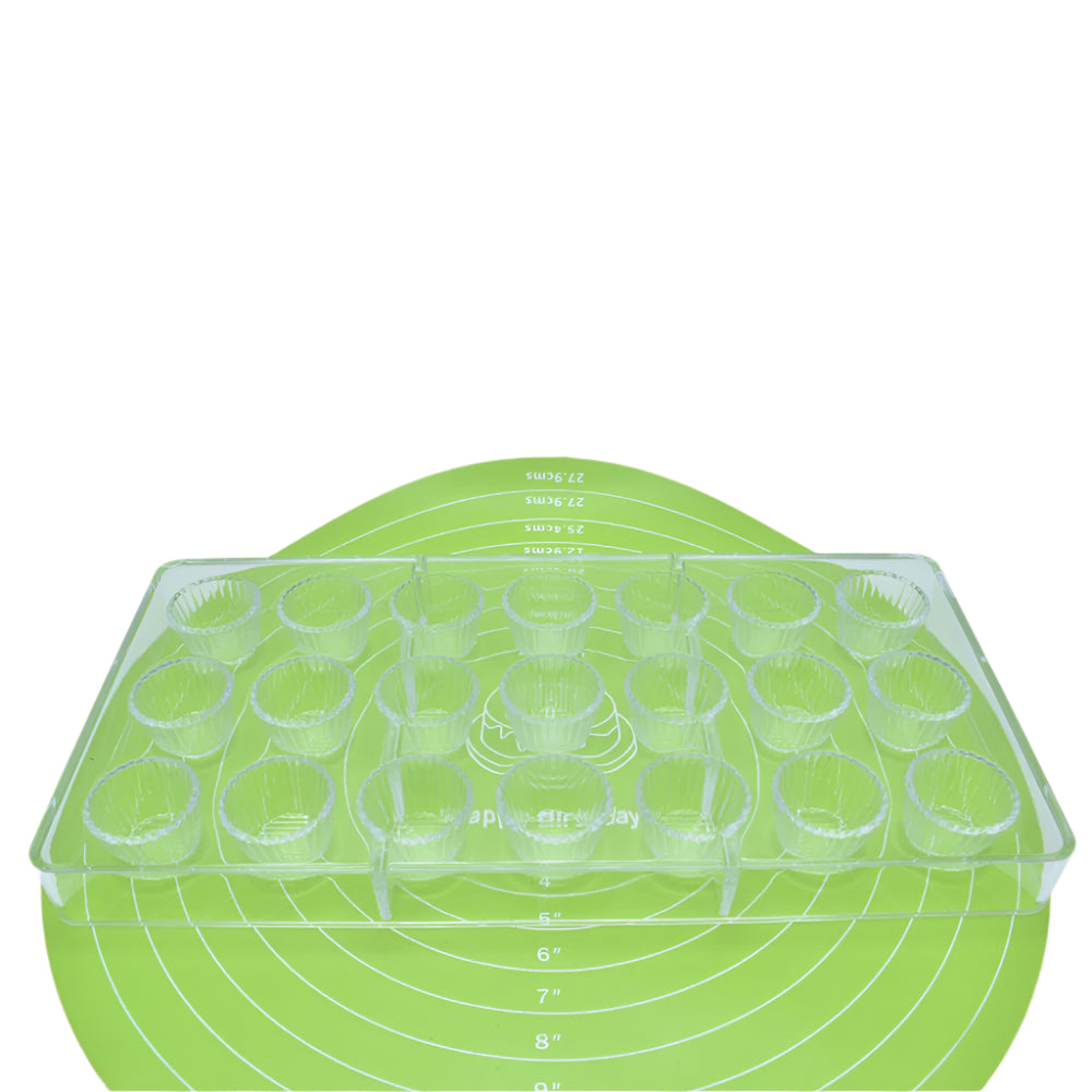 Deep Muffin Cups Shaped  Polycarbonate Chocolate Mold placed on a green baking mat against a white background for a detailed view.