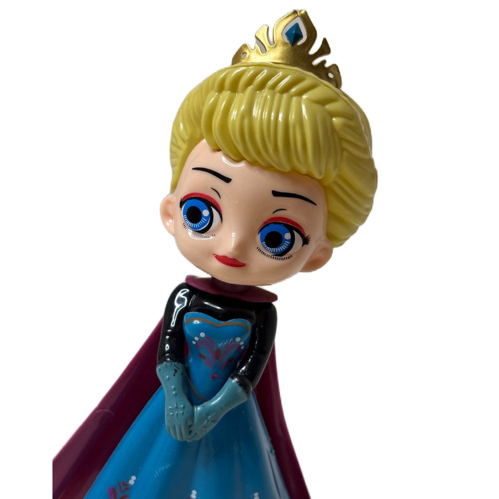 Close-up of Elsa-Inspired Blue Gown Doll Cake Topper on white background