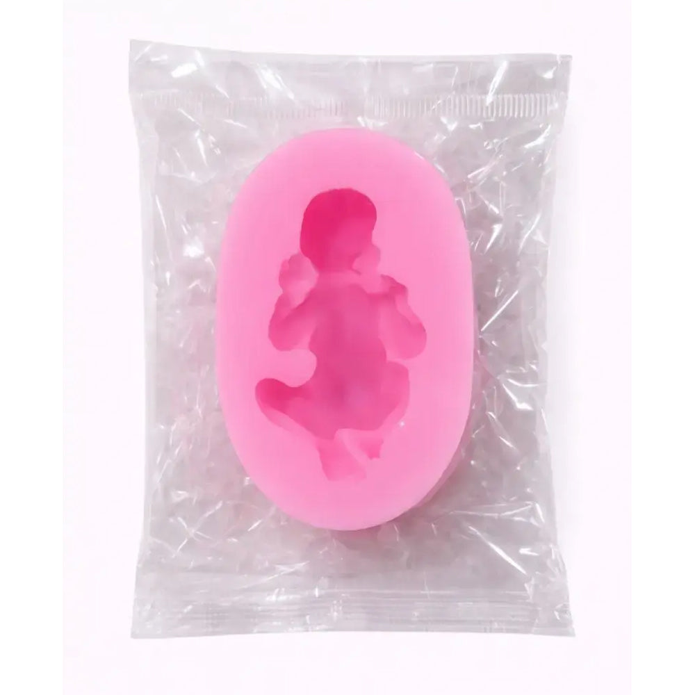 Pink silicone mold of a baby in a womb on a clear plastic bag.