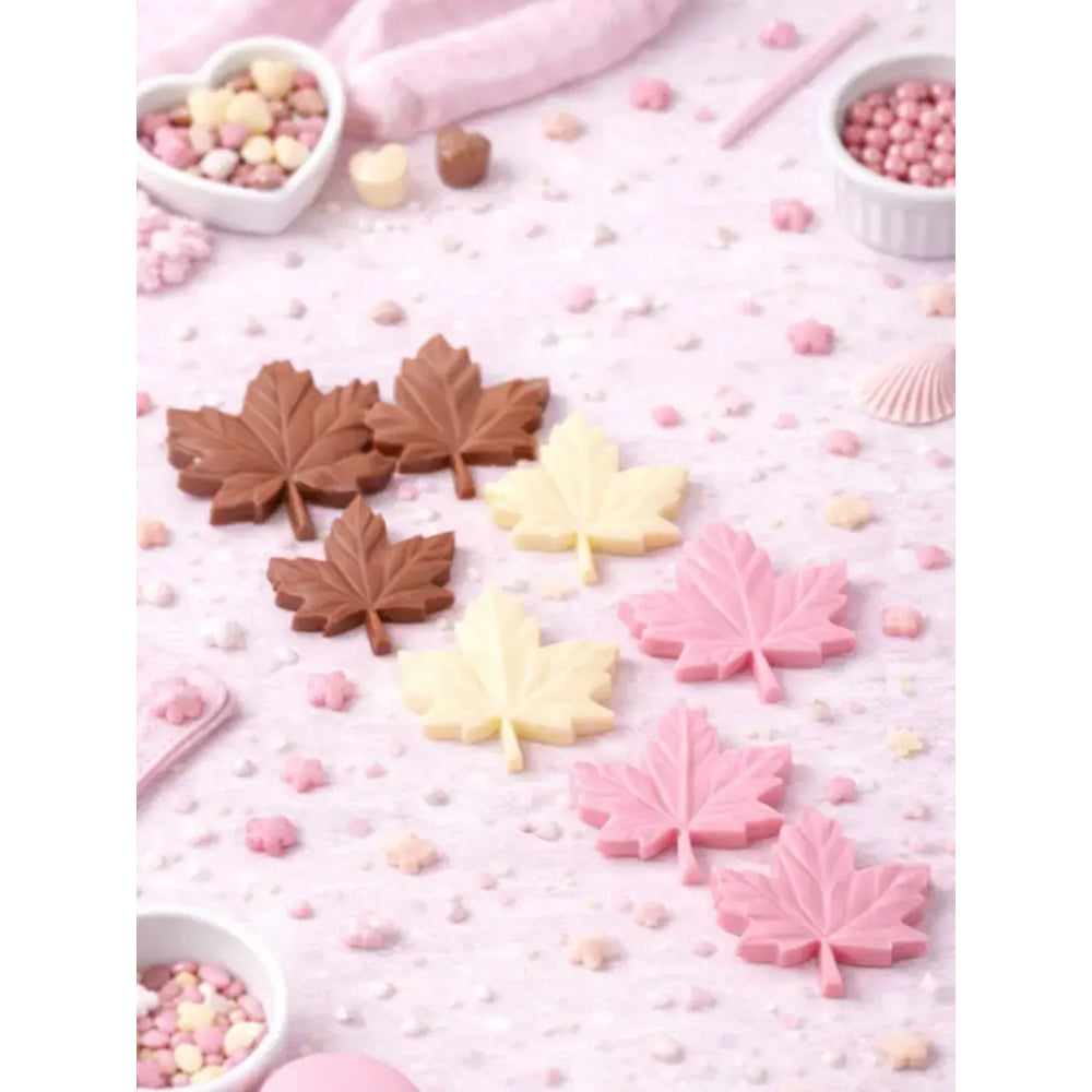 Chocolate leaf candies in brown, yellow, and pink on a pink background with small containers of candy.