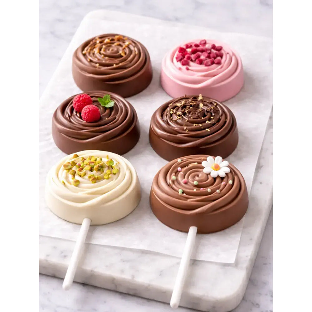 Chocolate-covered dessert pops on a marble surface