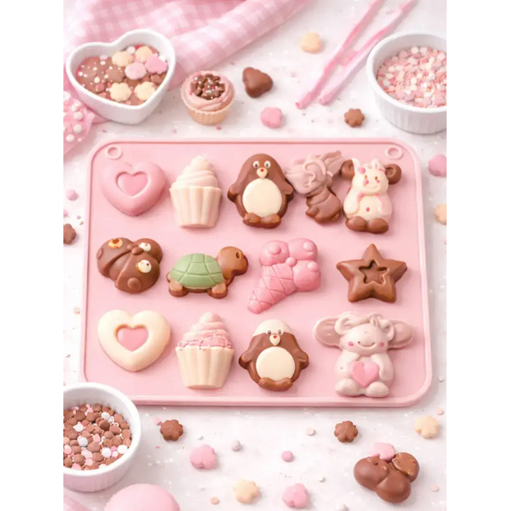 Pink silicone mold with animal and shape molds on a white surface with candy decorations.