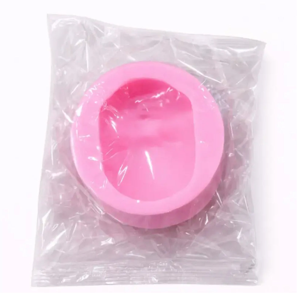 Pink silicone mold in a clear plastic bag on a white background