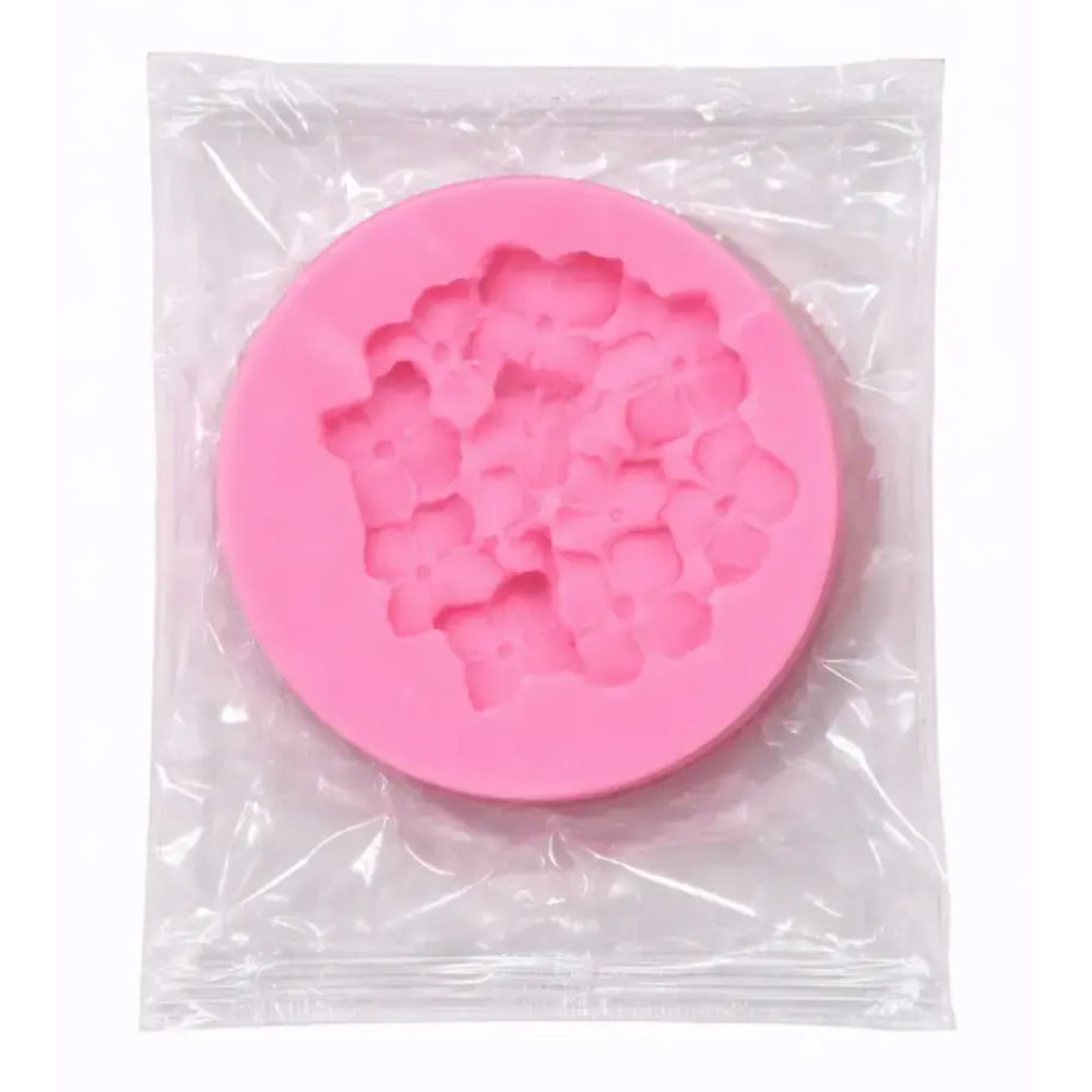 Pink silicone mold in a clear plastic bag on a white background