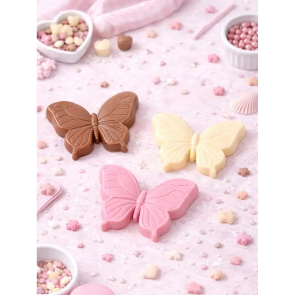 Butterfly-shaped candies in brown, pink, and yellow on a pink background with small containers of candies.
