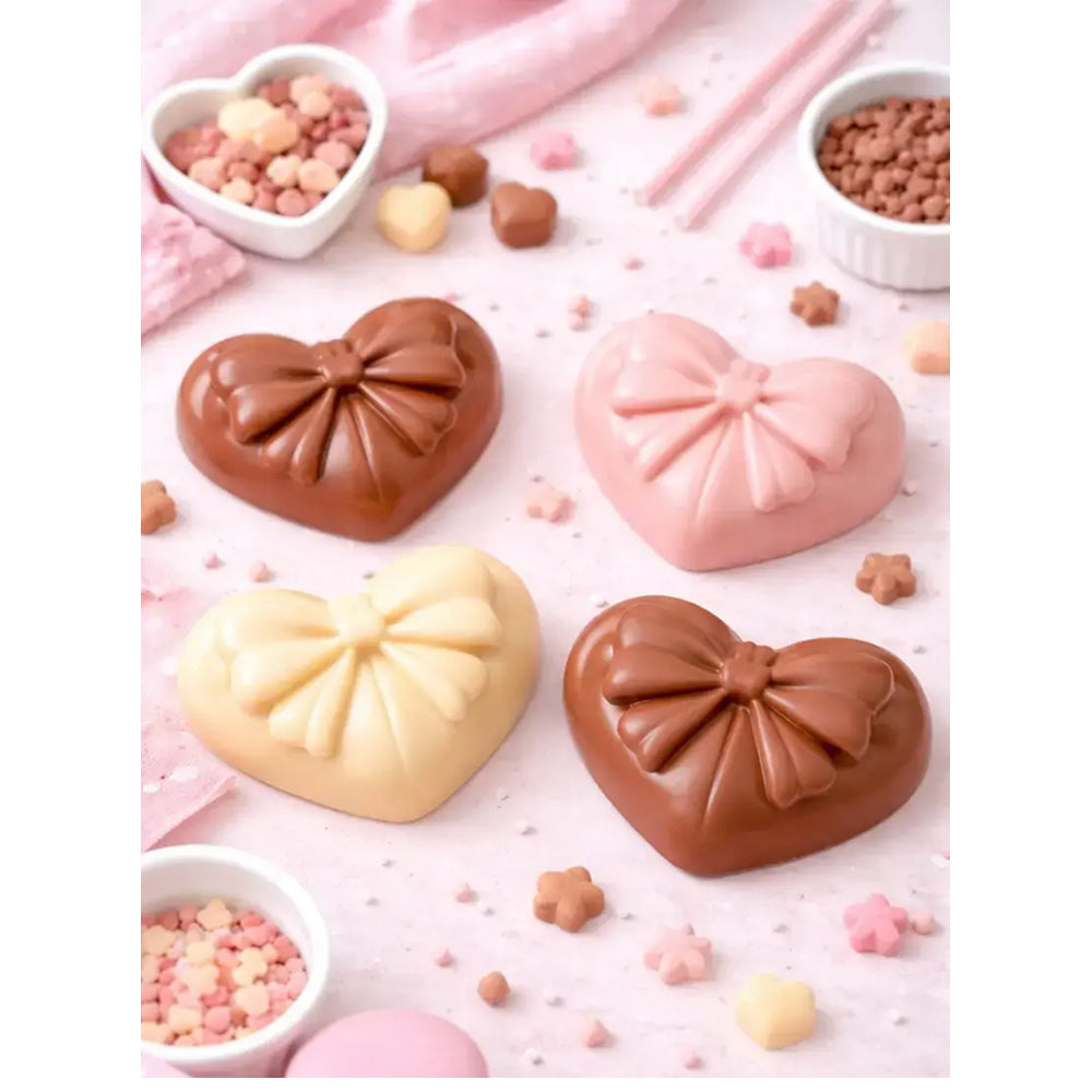 Heart-shaped pastries in chocolate, pink, and yellow on a light pink background with small bowls of toppings.