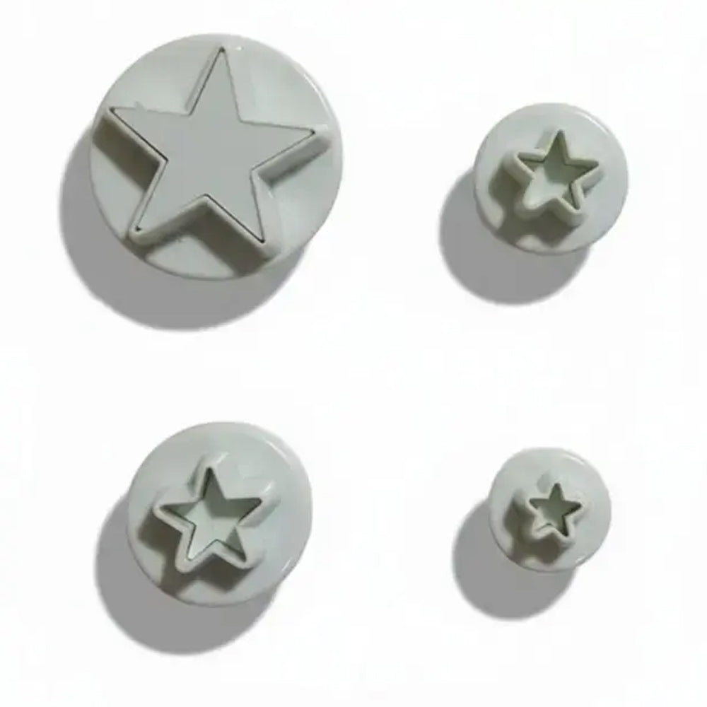 Set of star-shaped metal stamps on a white background