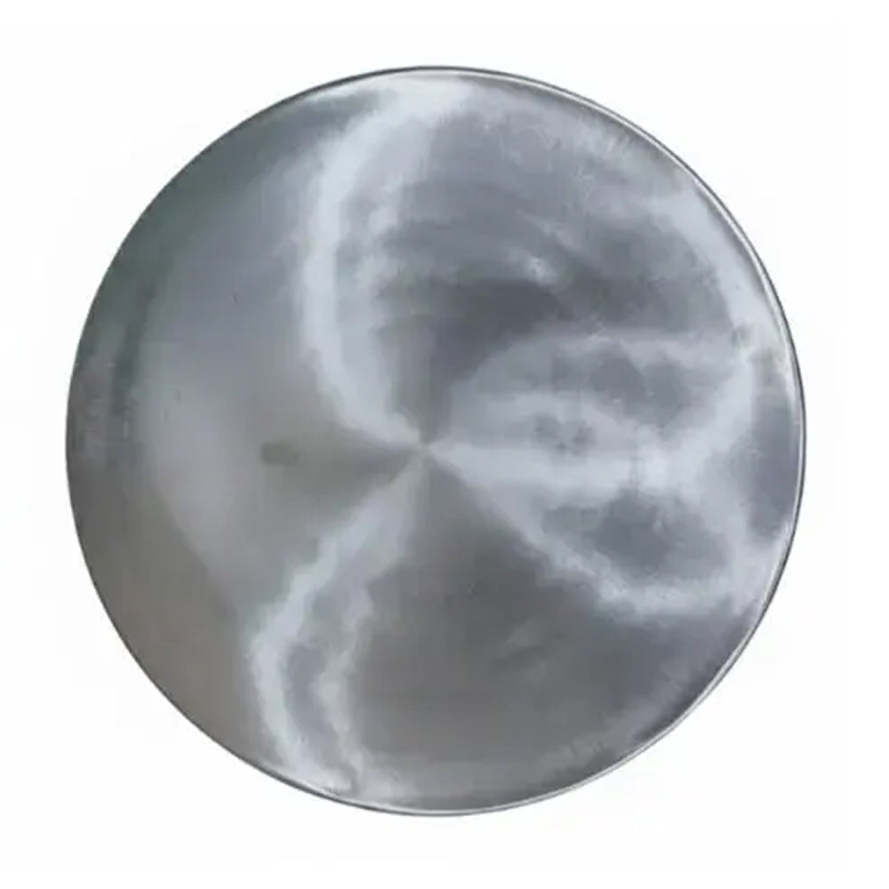 Round metallic object with a star-like pattern on a white background