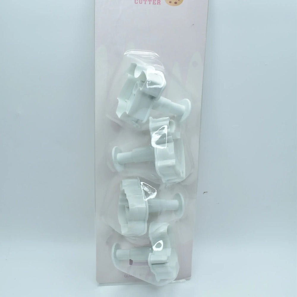 Set of plastic cookie cutters in packaging on a white background