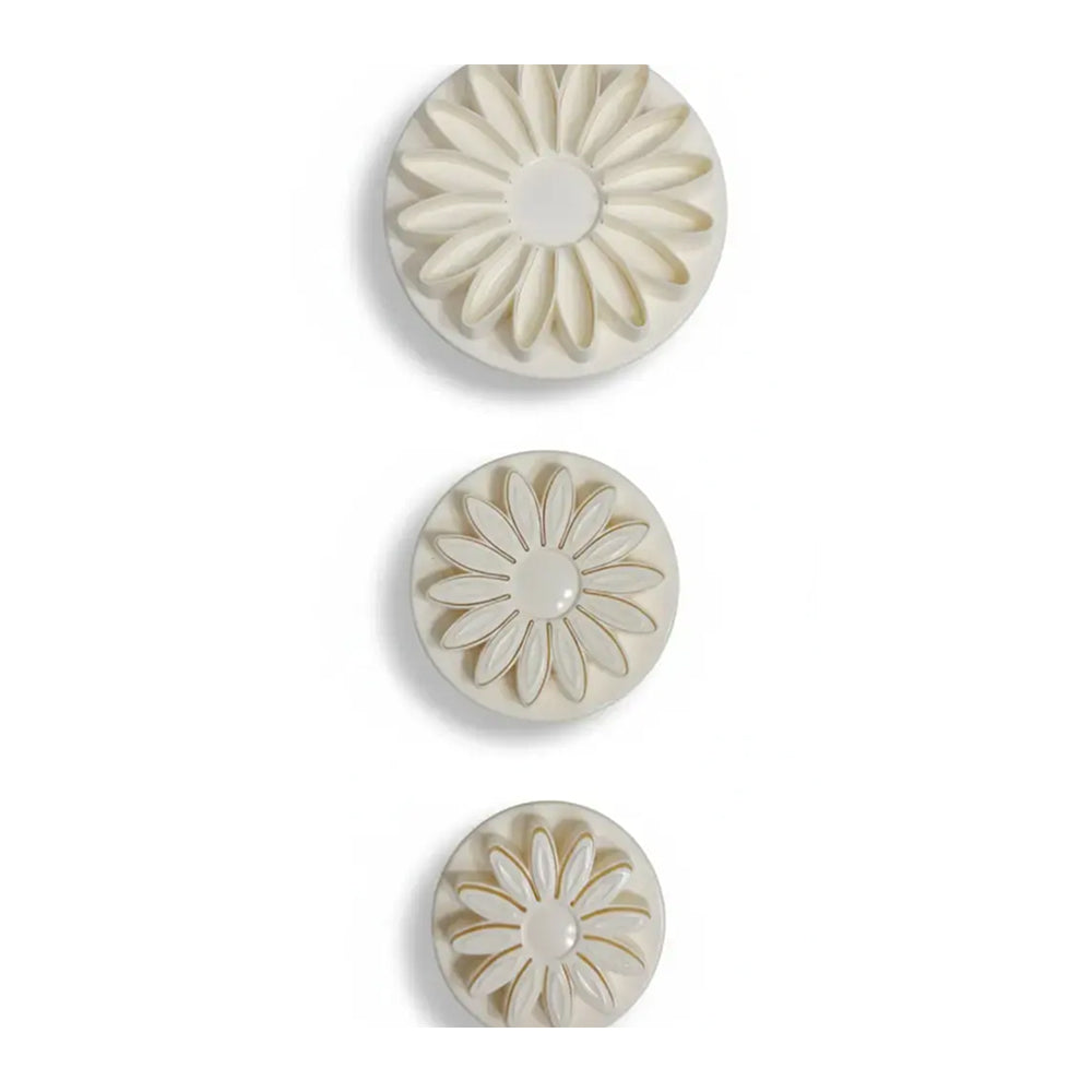 Three decorative buttons with floral patterns on a white background
