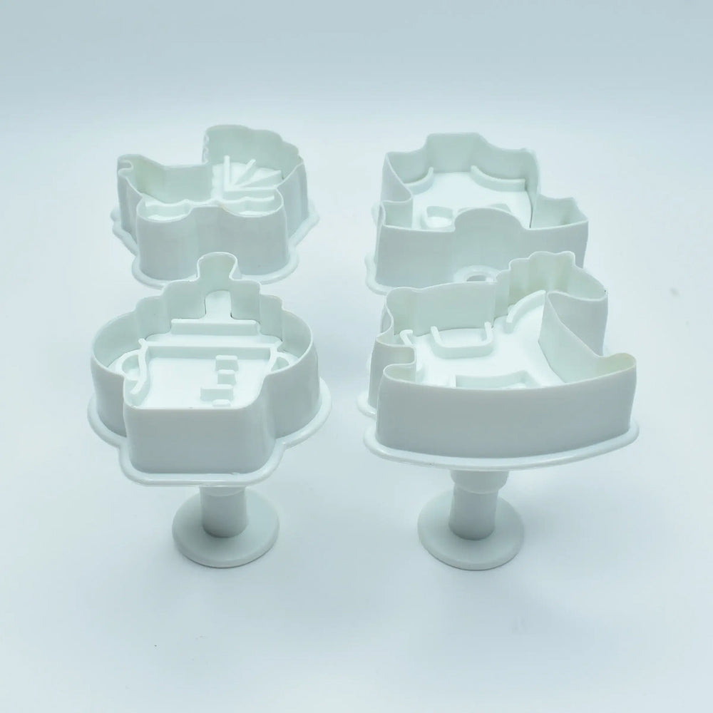 Set of white cookie cutters shaped like musical instruments on a light gray background