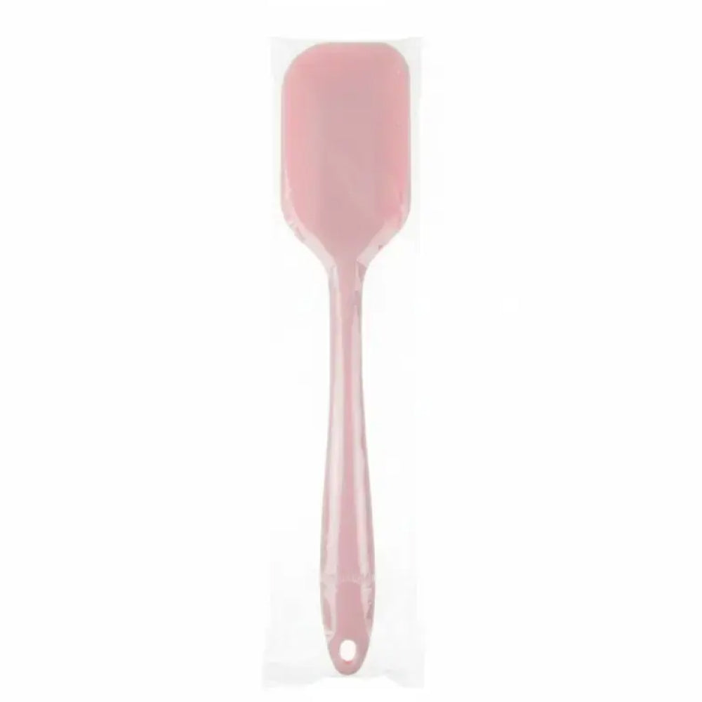 Pink spatula on a white background