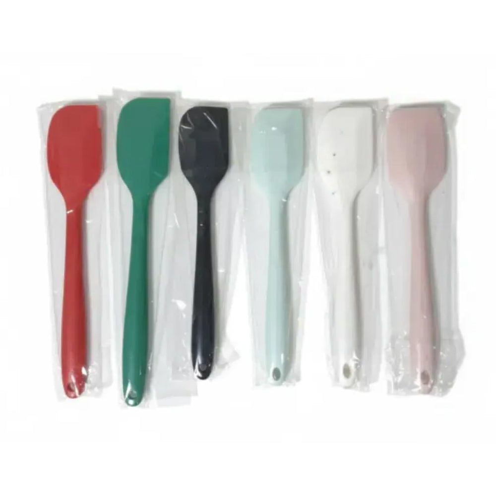 Set of colorful spatulas in clear packaging on a white background