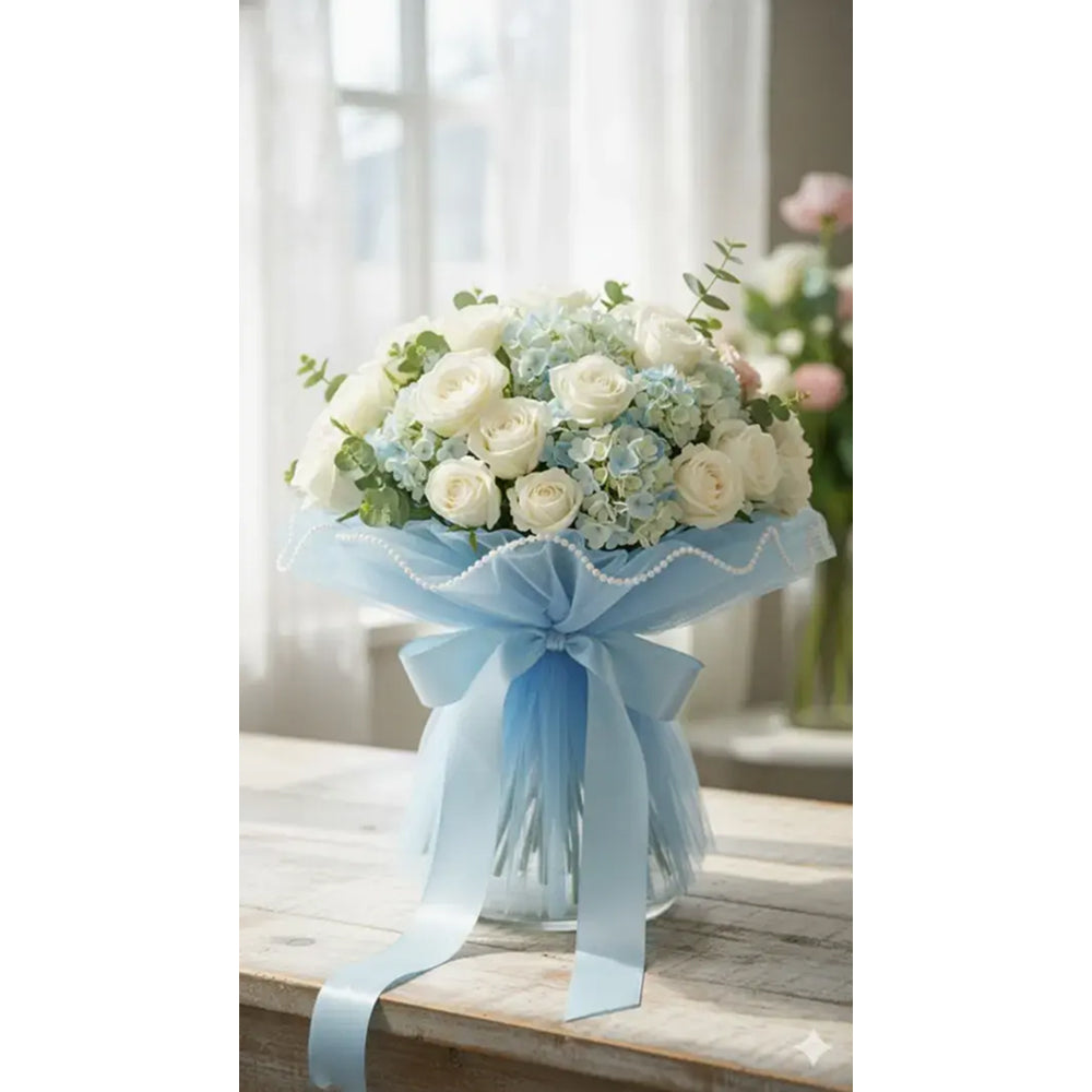 Bouquet of flowers with a blue ribbon on a wooden table.