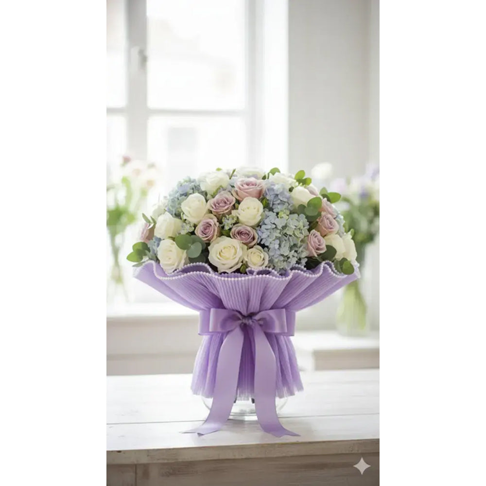 Bouquet of flowers wrapped in purple paper on a windowsill