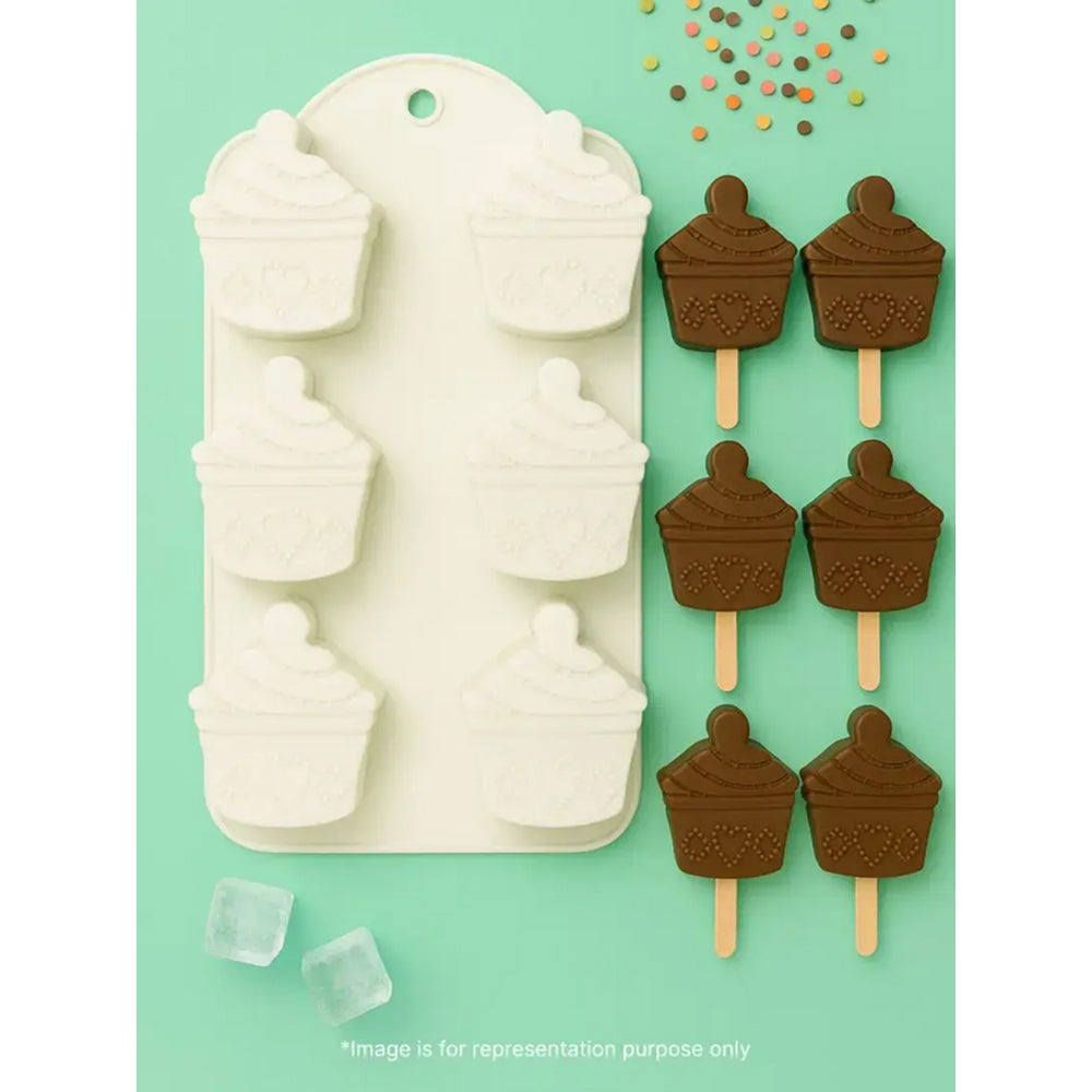 Silicone mold for making ice cream pops with chocolate-dipped popsicles on a green background
